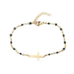 Cross bracelet in gold-plated metal with interlaced black pearls